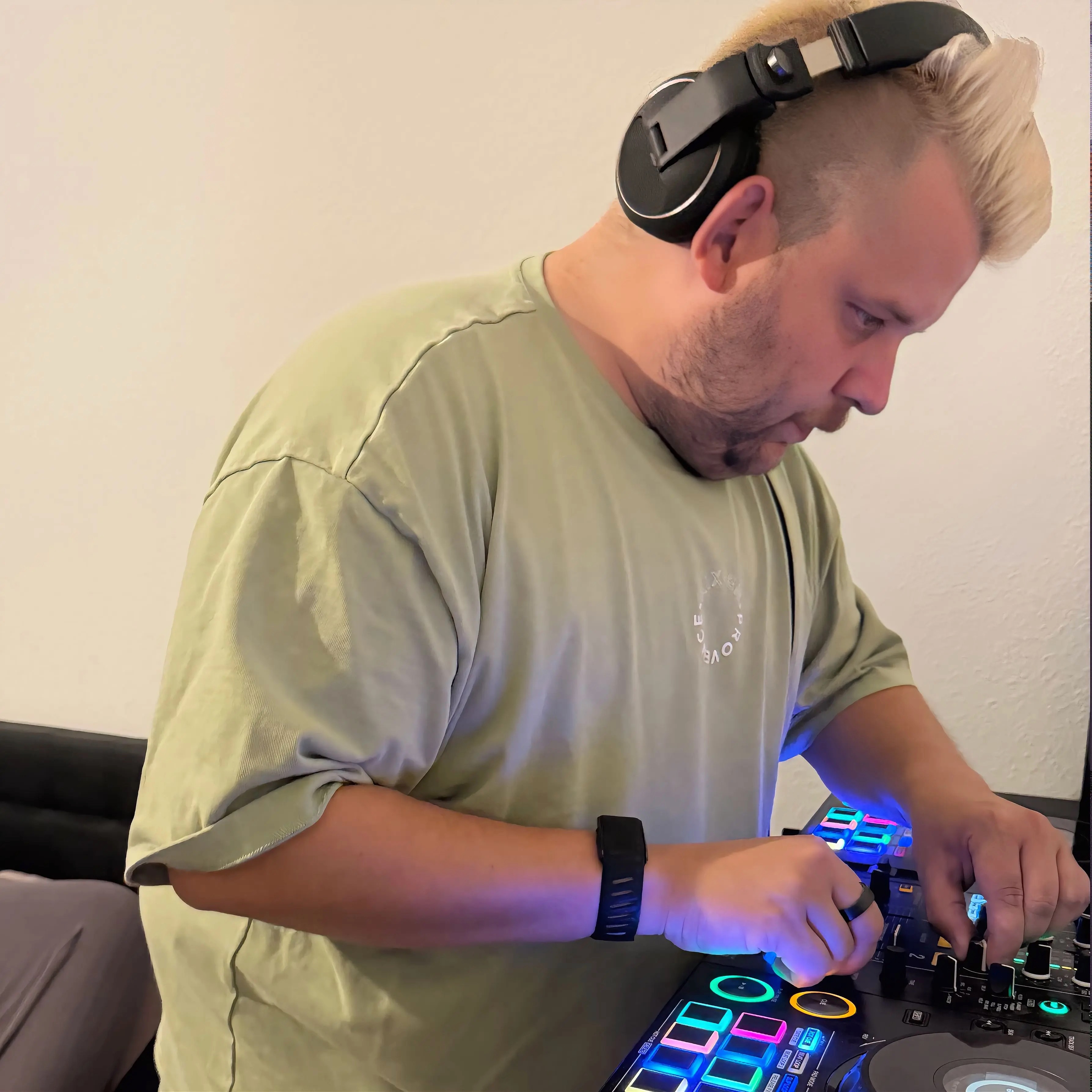 Maximilian Mayer mit Kopfhörern beim Auflegen am DJ-Controller